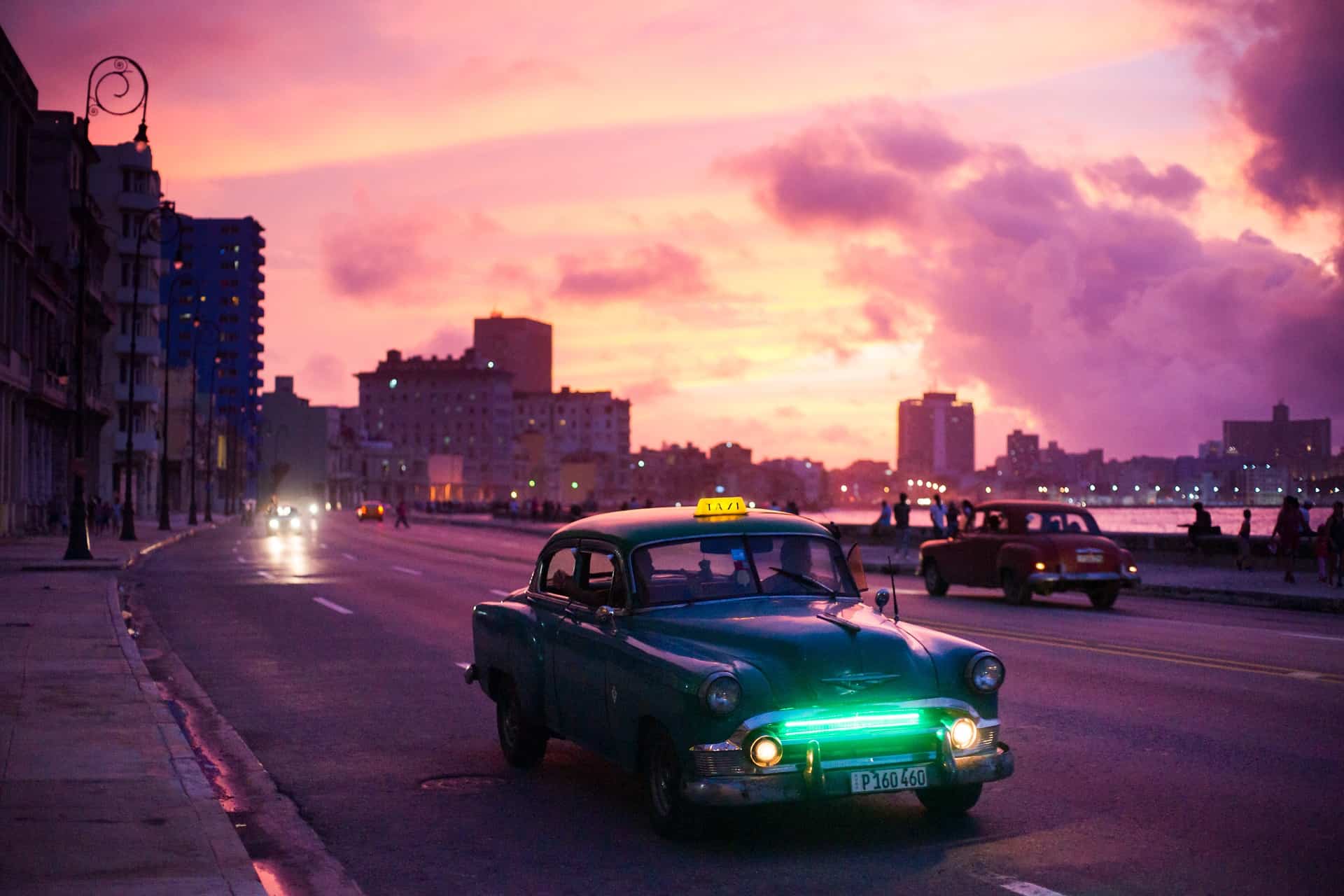How to travel to Cuba as an American - an old fashioned car on the Malecon in Cuba