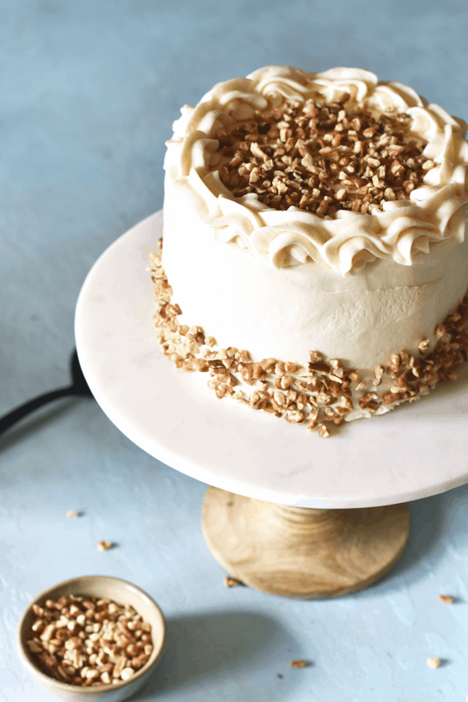 Old Fashioned Carrot Cake Recipe on a beautiful pedestal with blue background