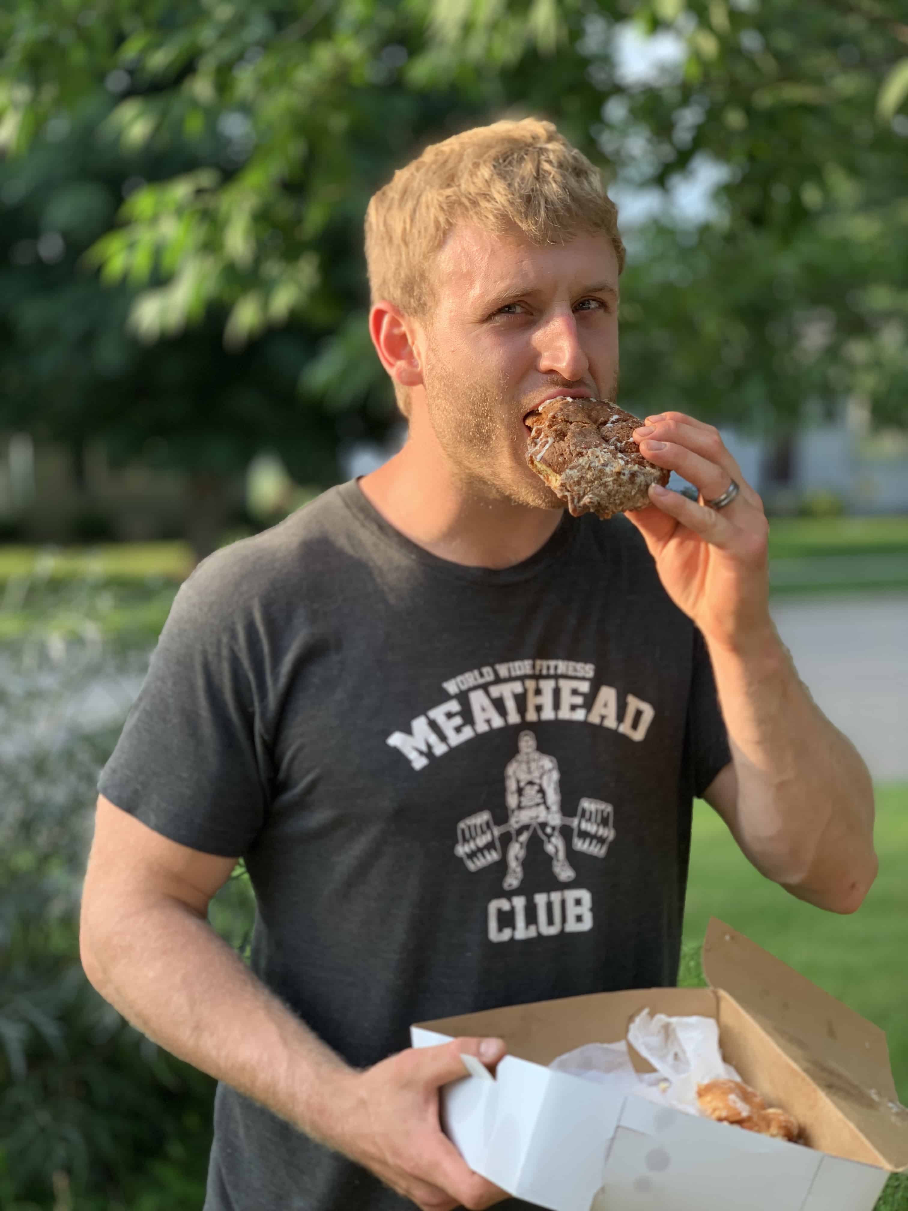 Butler County Donut Trail man eating a donut outside
