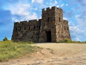 A picture of a small castle called Coronado Heights with a bright blue sky behind it