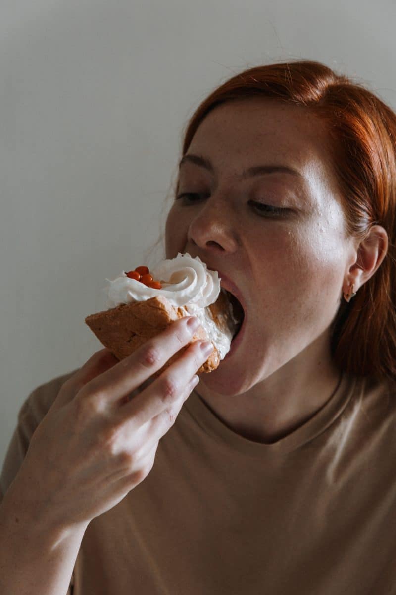 Loving food can be a challenge when trying to lose weight. Here are some tips on how to lose weight when you love food. Picture of a woman eating a large slice of pie.