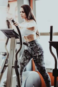 how to build muscle: a picture of a woman on an eliptical