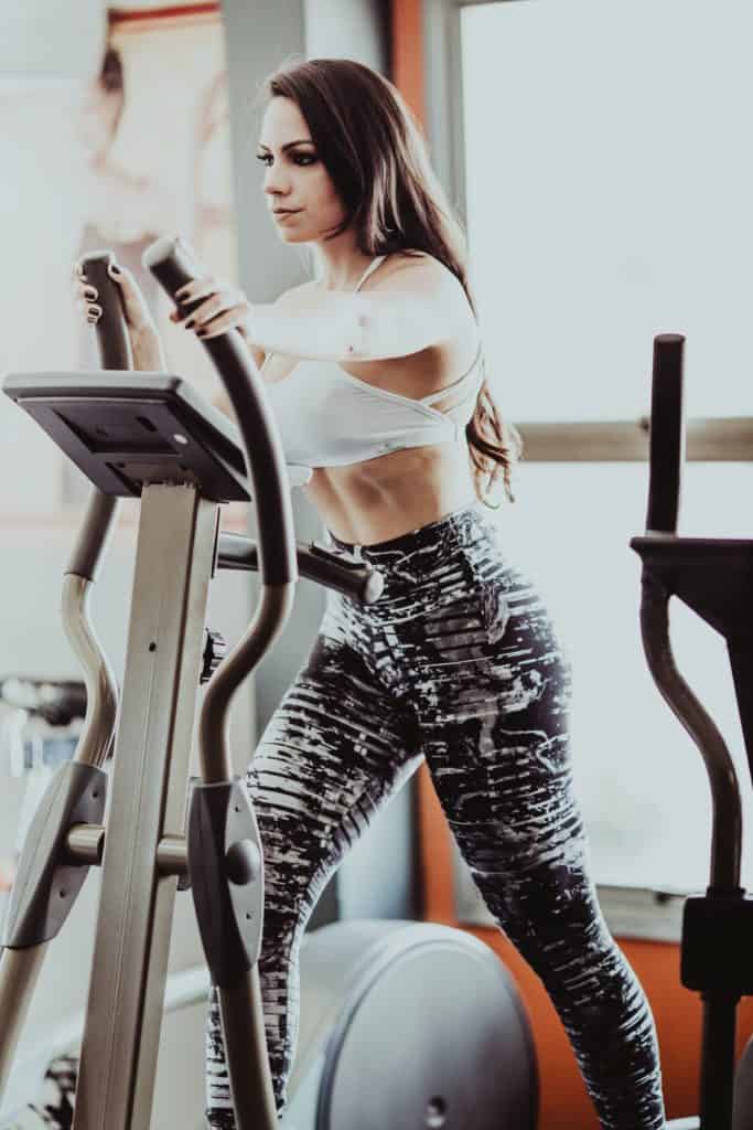 How to Build Muscle. Picture shows a woman on an elliptical.