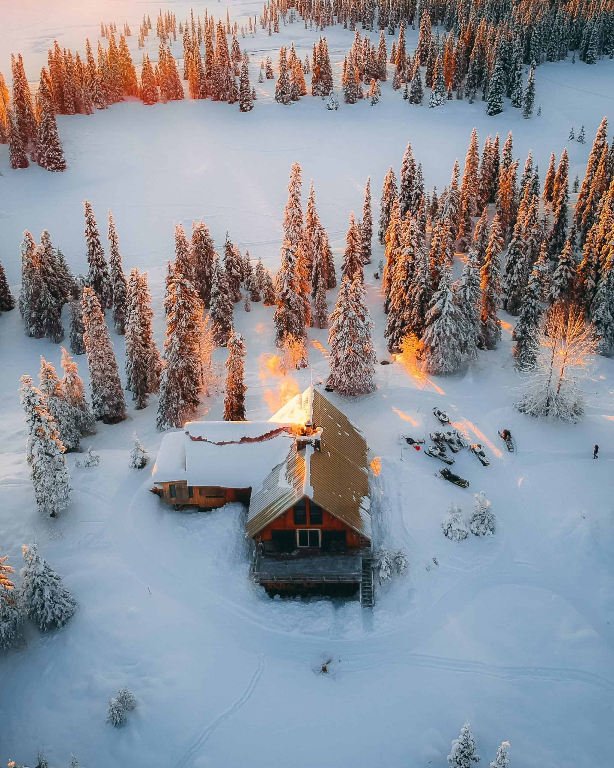 how to save on heating bill: picture of a cabin surrounded by snow