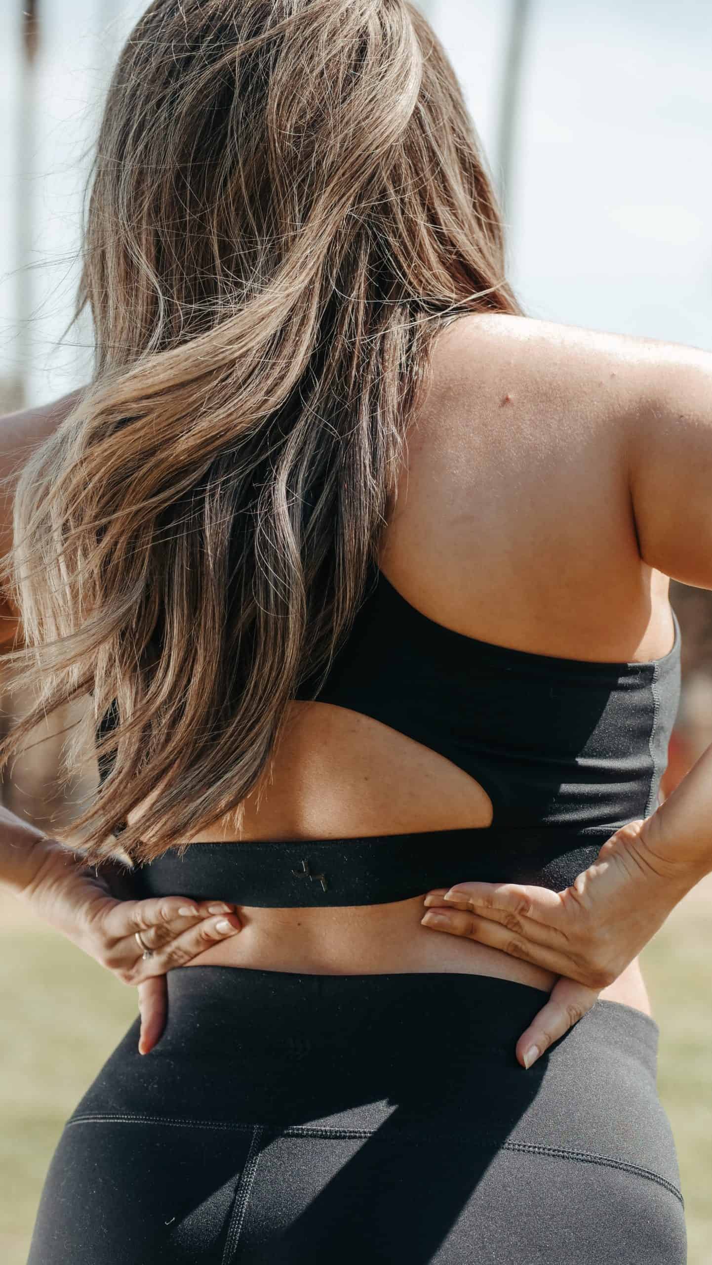 how to heal fast from surgery: woman with long hair wearing athletic clothes