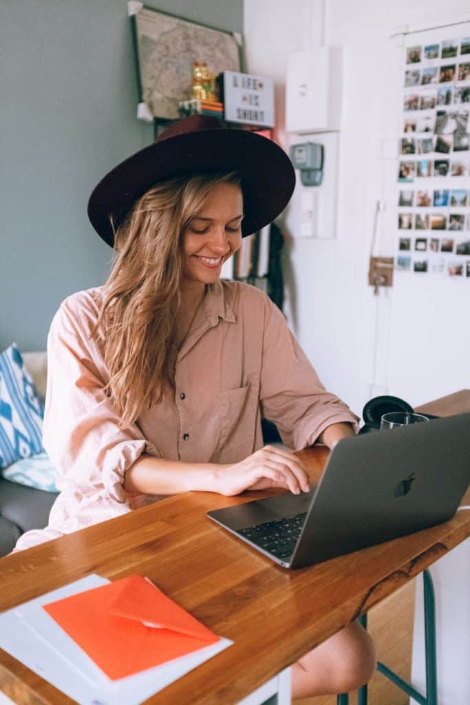 Pursue your passion; smiling woman using laptop