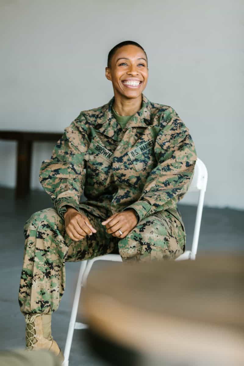 photo of soldier sitting on a folding chair