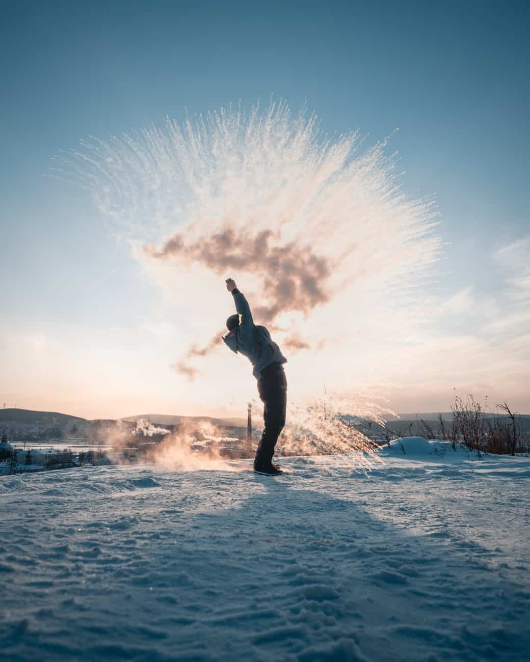 man throwing snow in winter