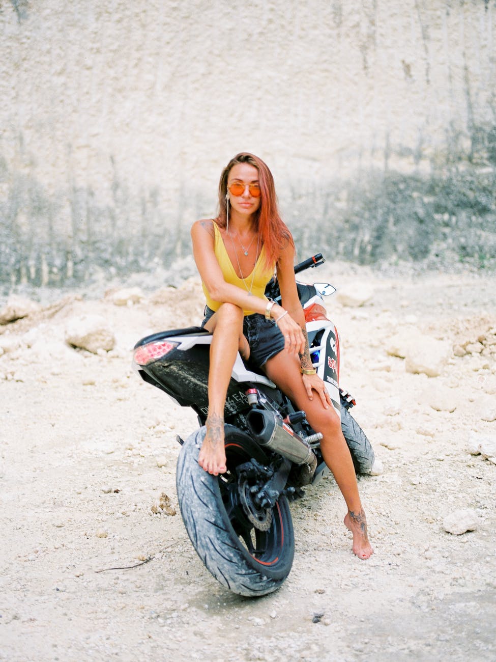 woman in sunglasses sitting on motorcycle