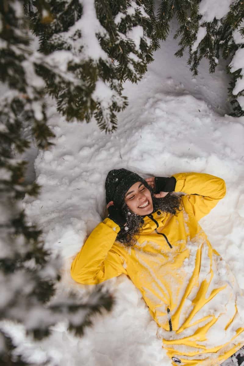 a woman lying down on snow
