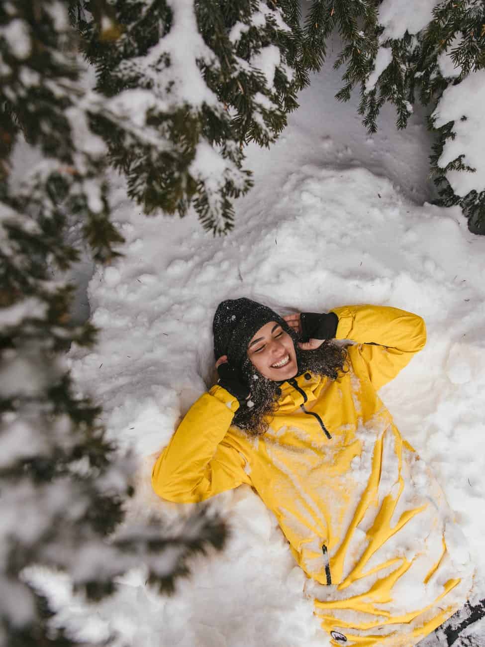 a woman lying down on snow