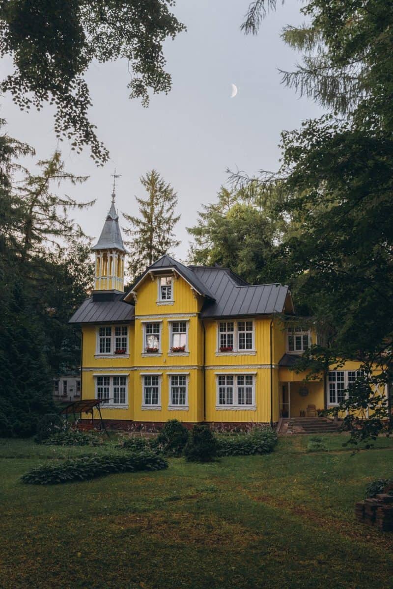 yellow mansion among trees