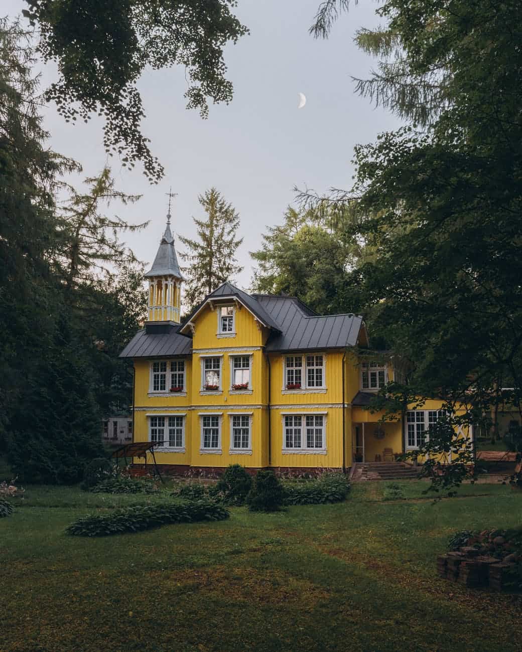yellow mansion among trees
