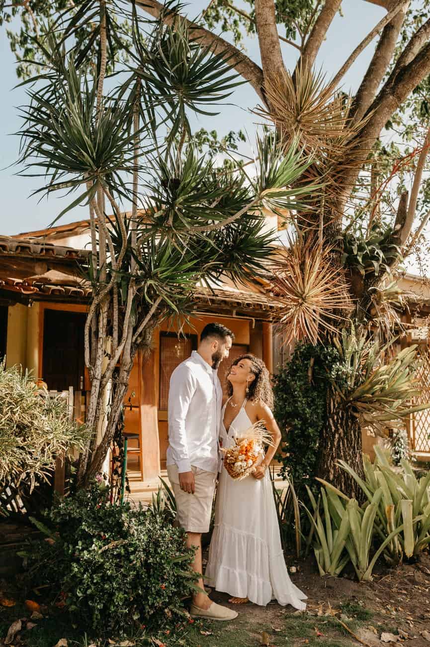 newlyweds standing together smiling at each other