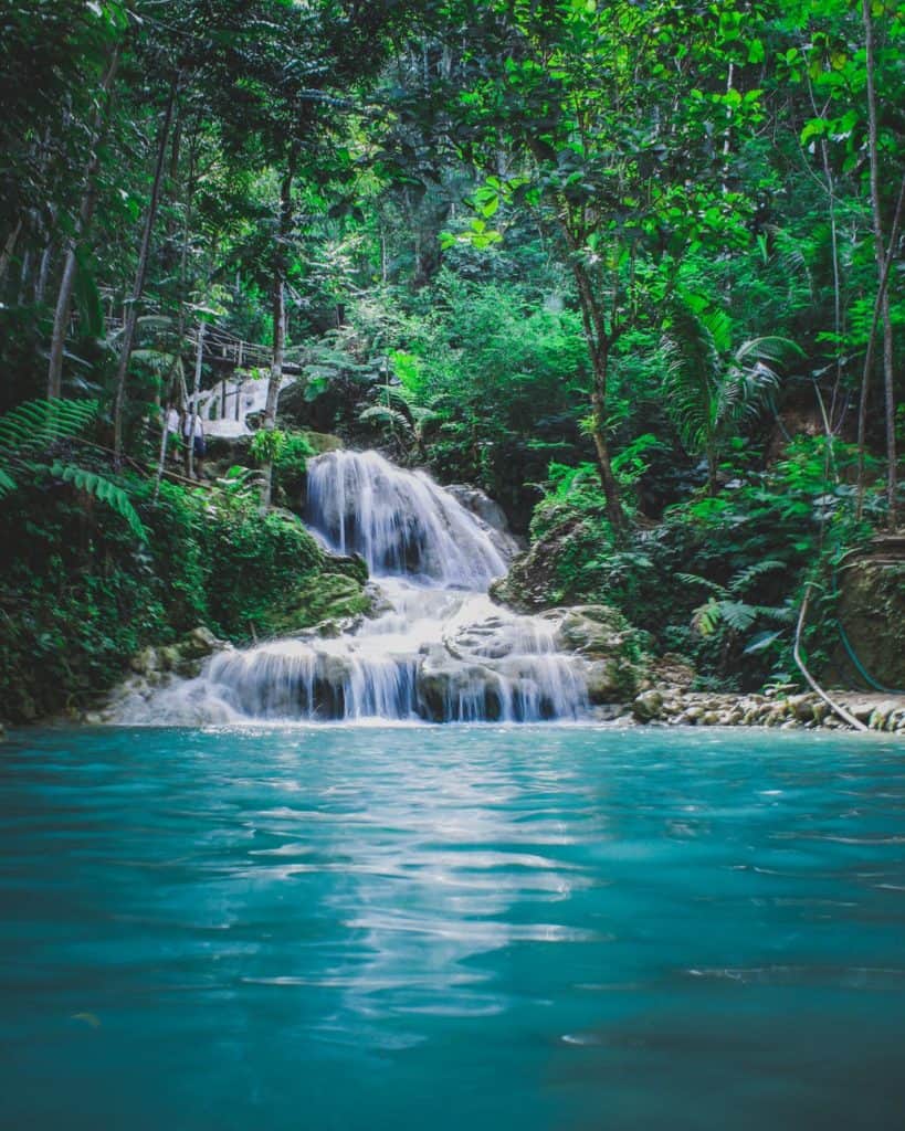 photography of waterfalls between trees; how to be more positive