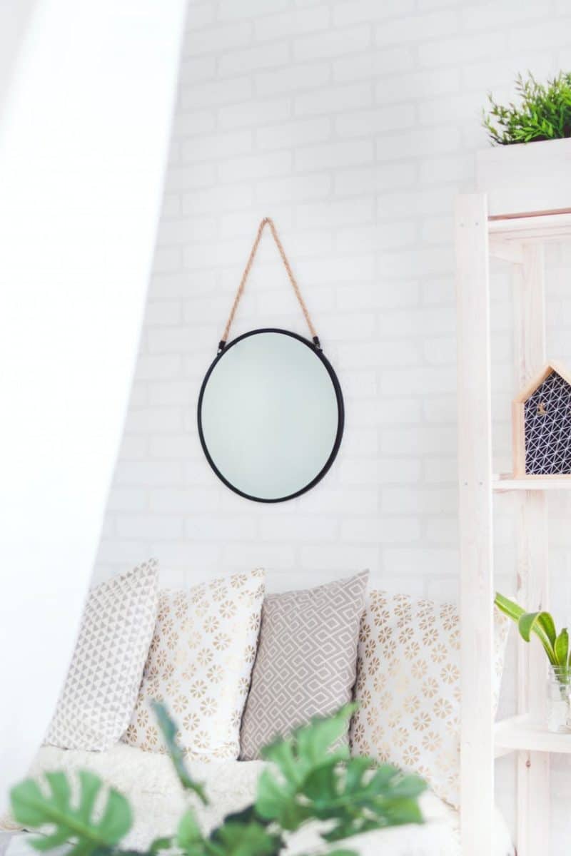 round black framed mirror on the wall