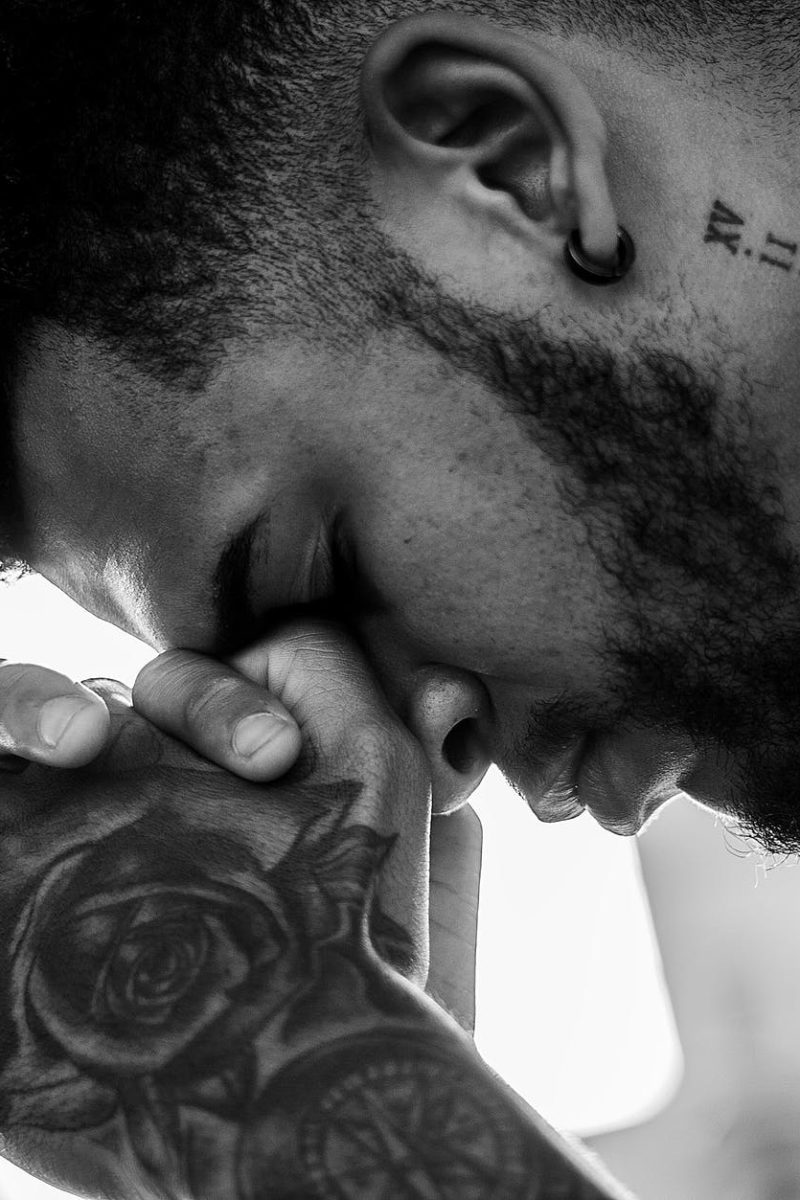 man tattooed praying