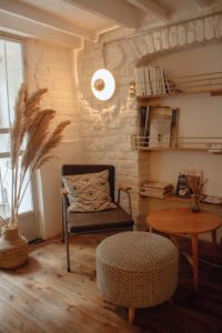 armchair near table and ottoman
