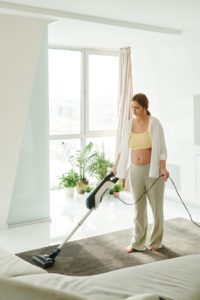 a woman using a vacuum cleaner