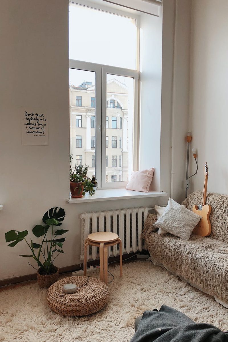 round brown wooden stool near brown sofa