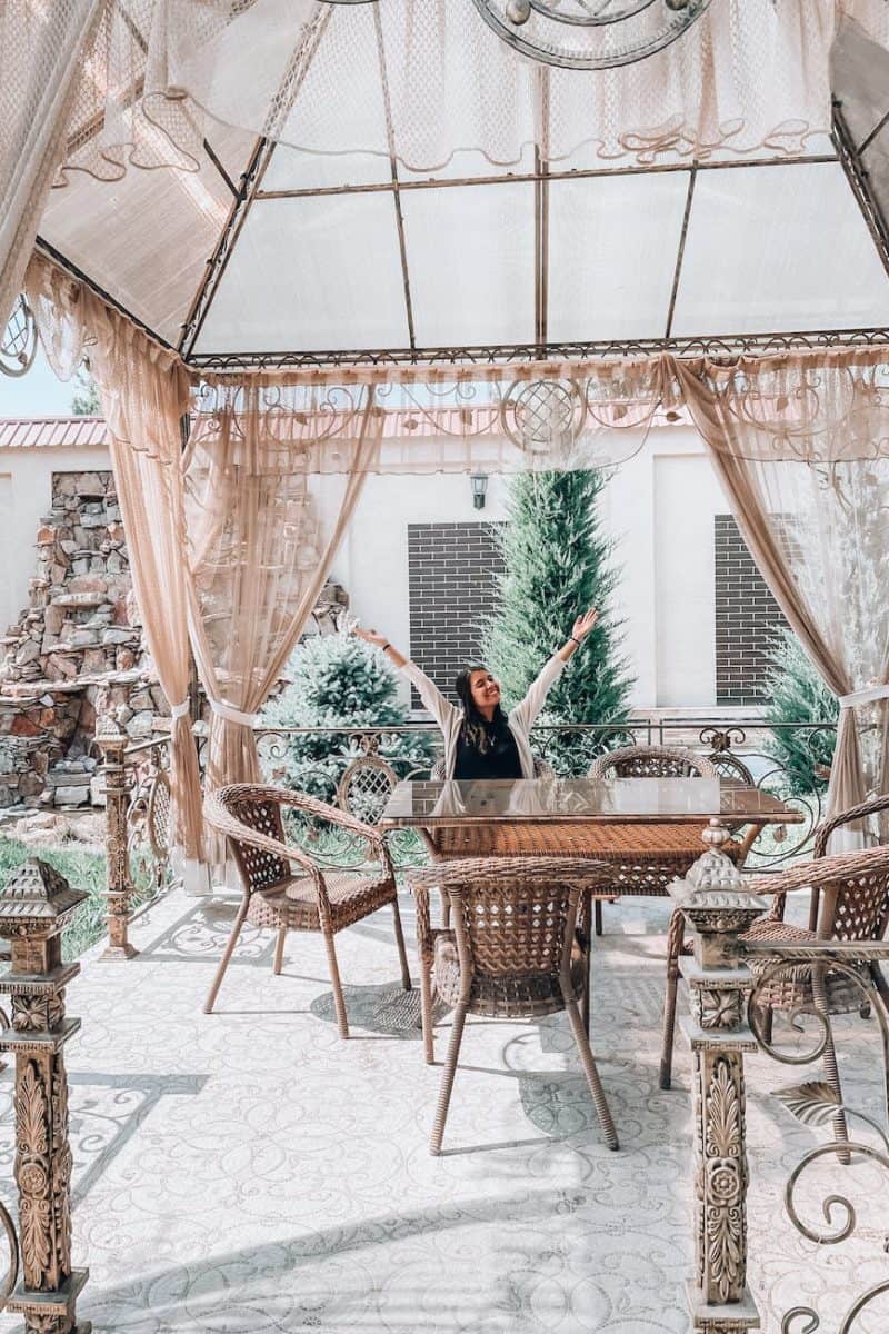 woman sitting on outdoor dining chair