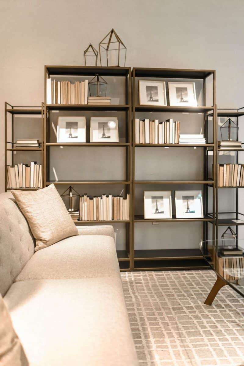 brown wooden shelf and beige fabric sofa