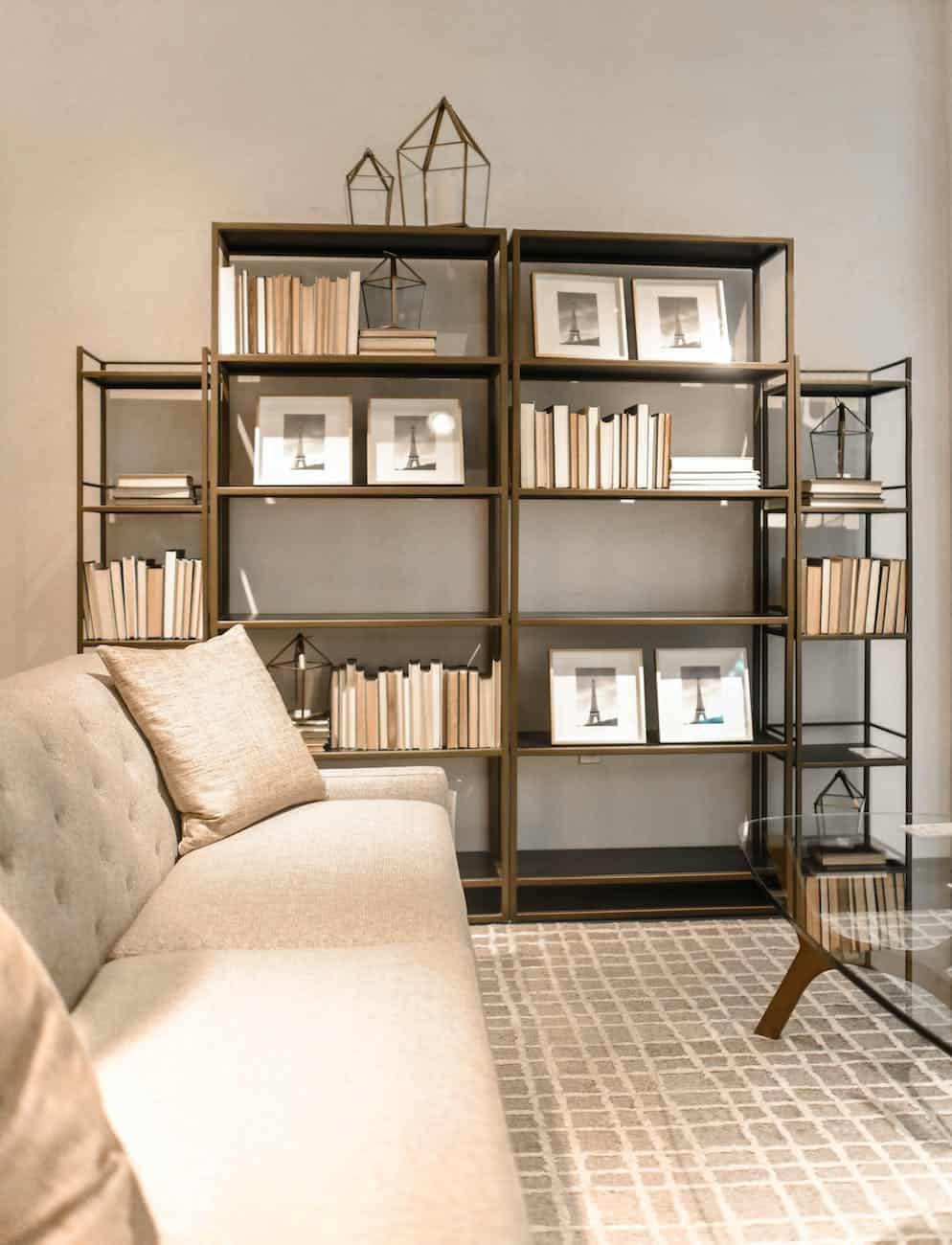 brown wooden shelf and beige fabric sofa