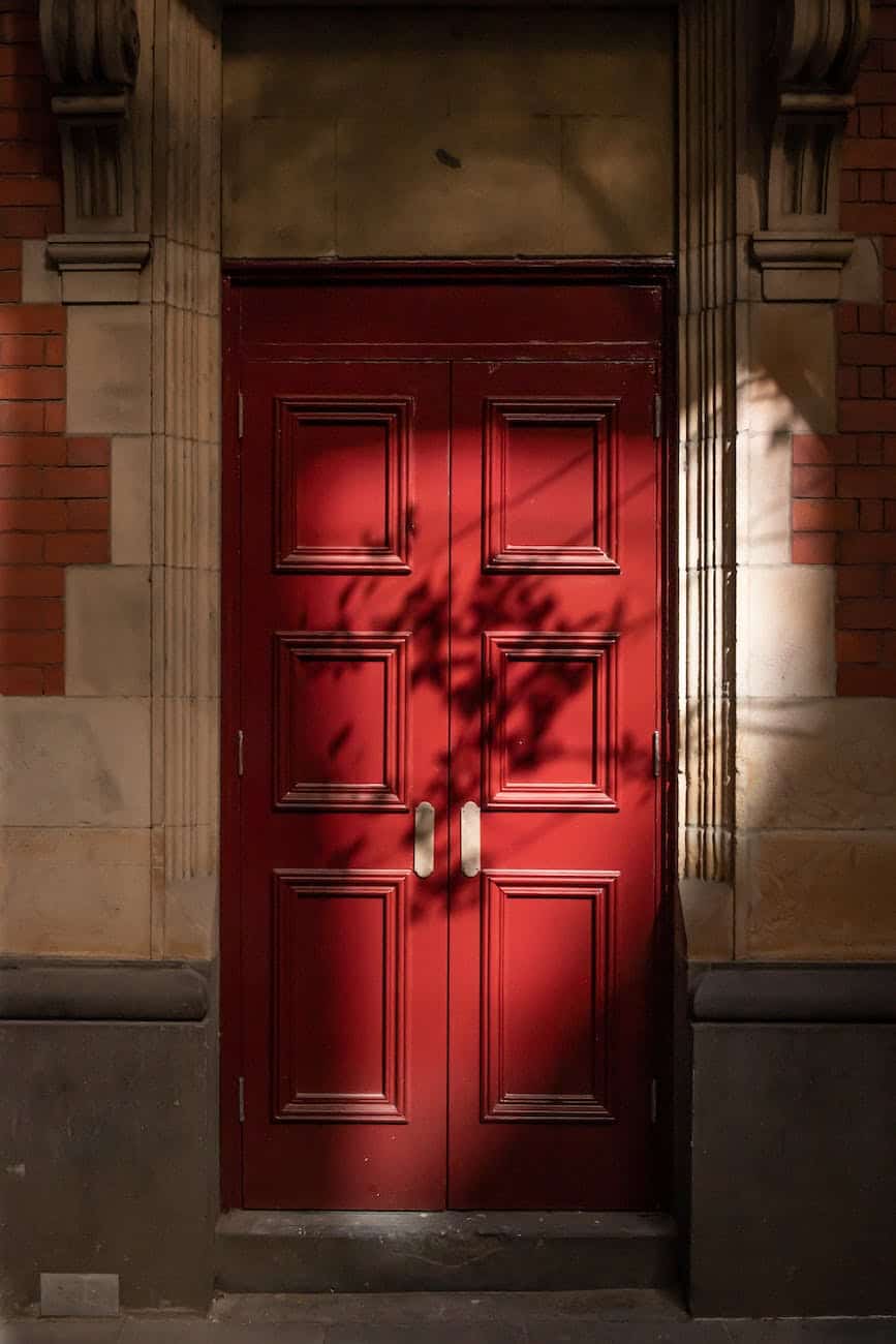 red wooden door on daylight