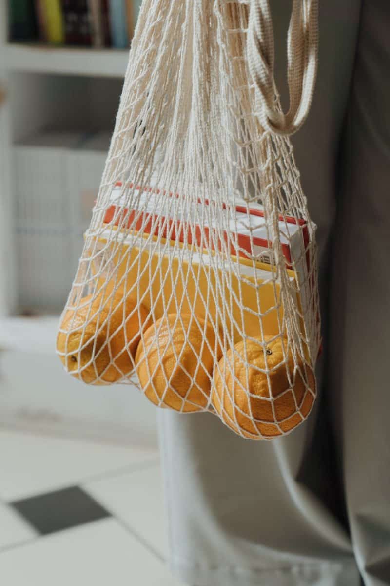 orange and yellow net on white plastic bag
