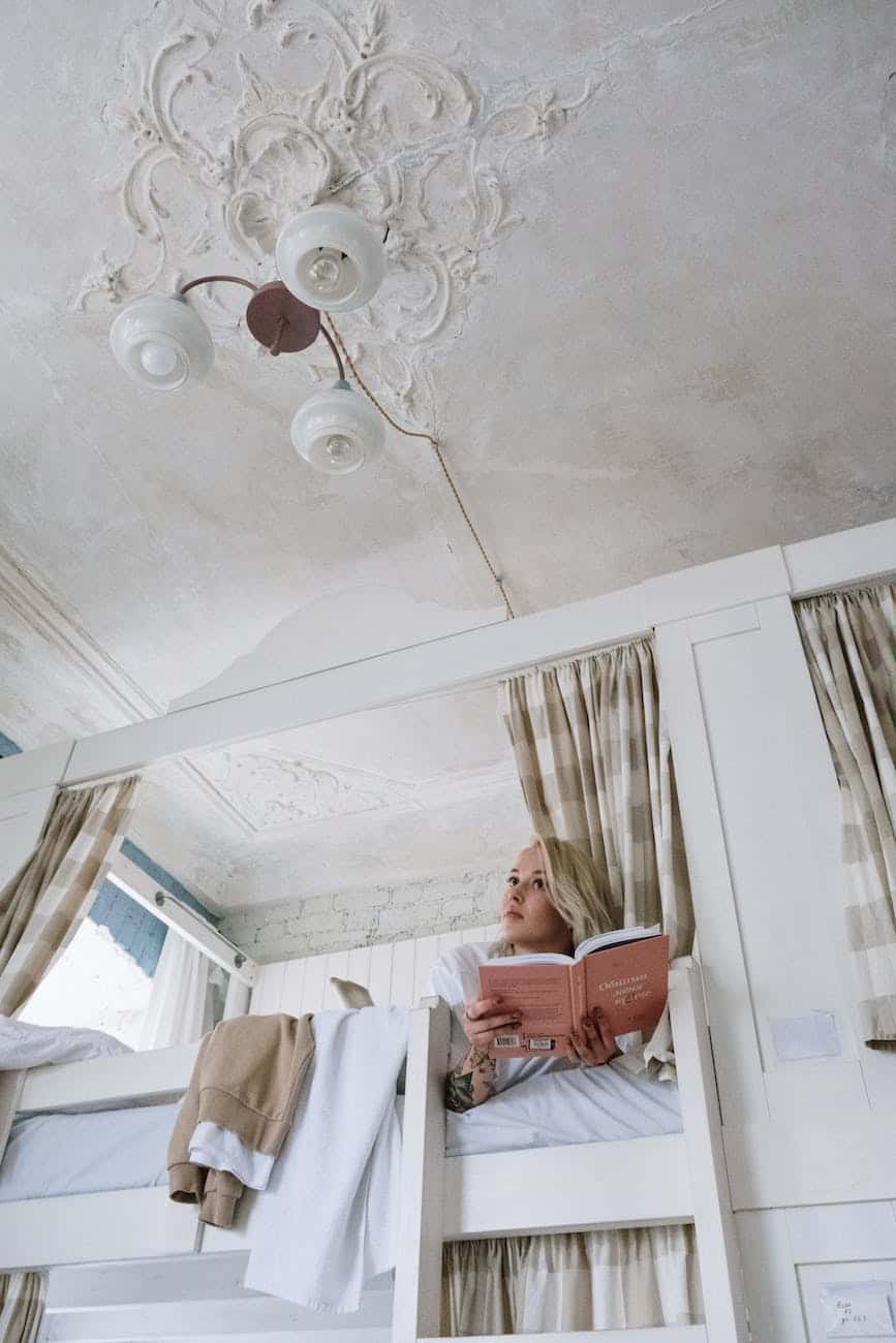 woman lying on top of a bunk bed