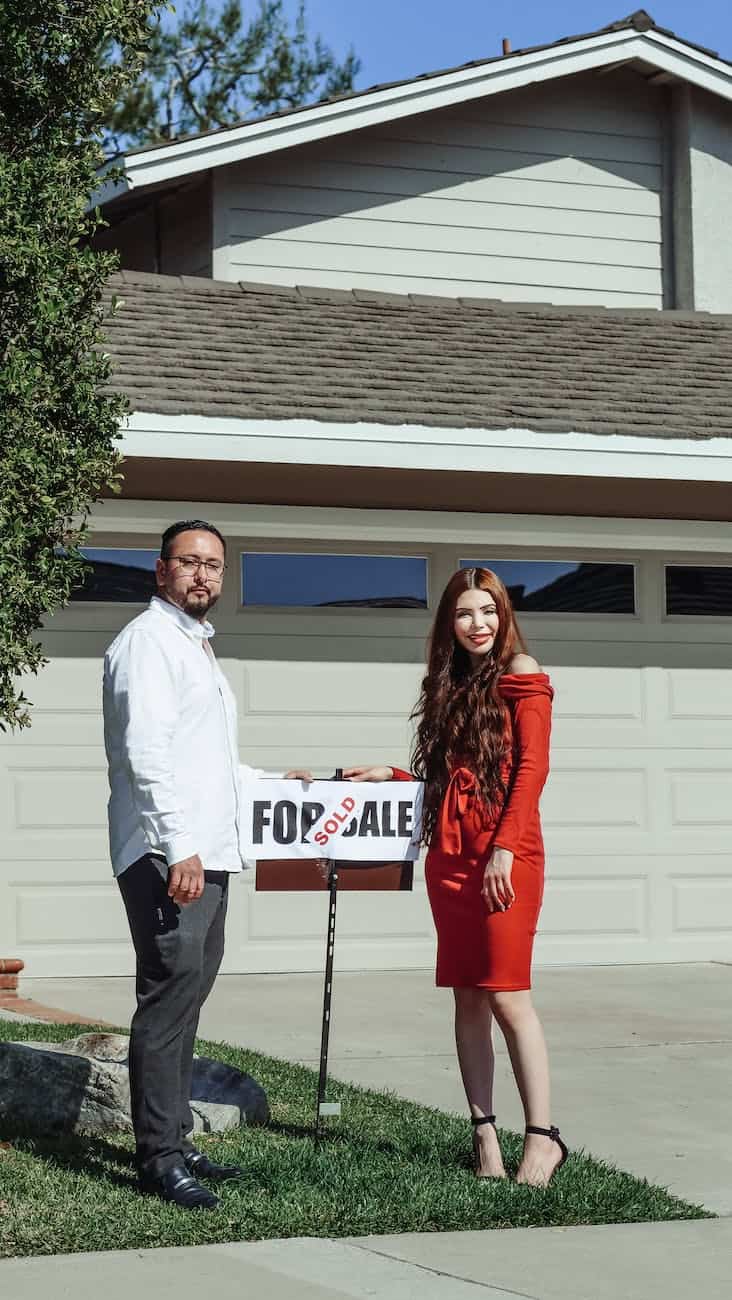 man and woman standing in front of their house