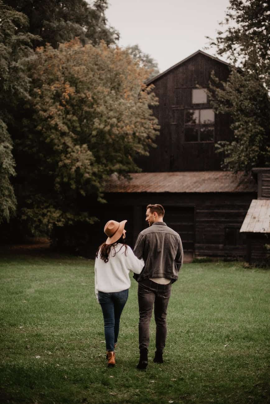 man and woman standing on green grass