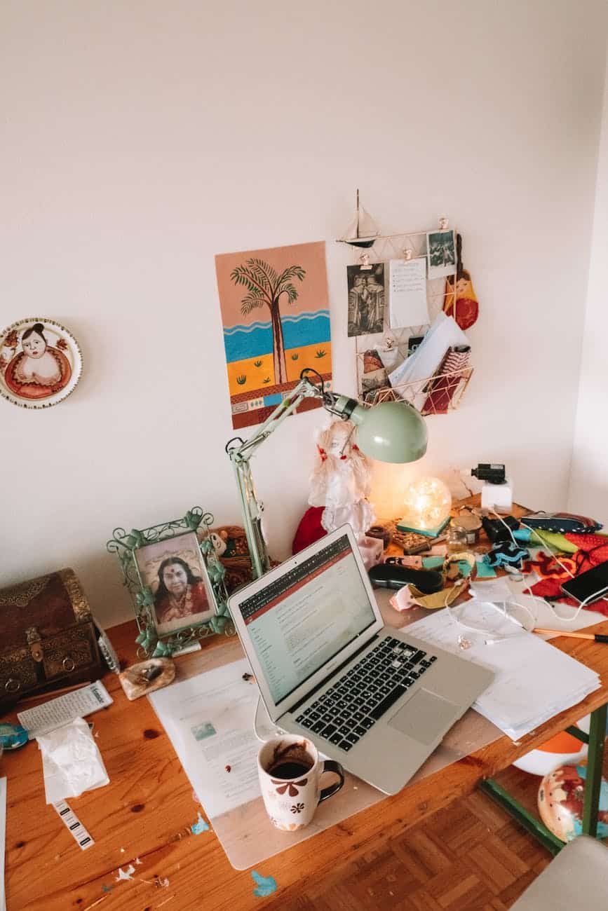 laptop on table beside mug