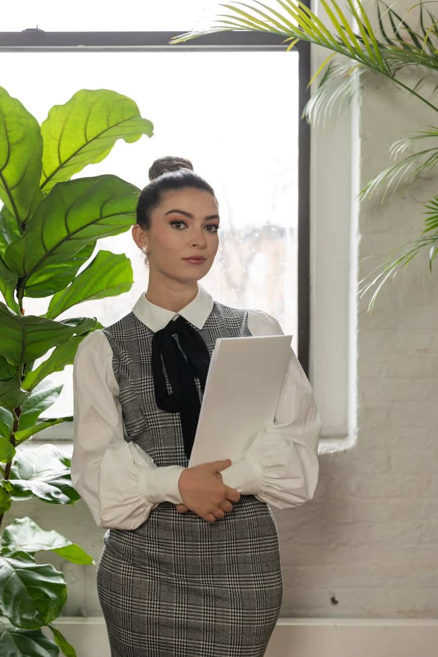 office worker standing in front of a window