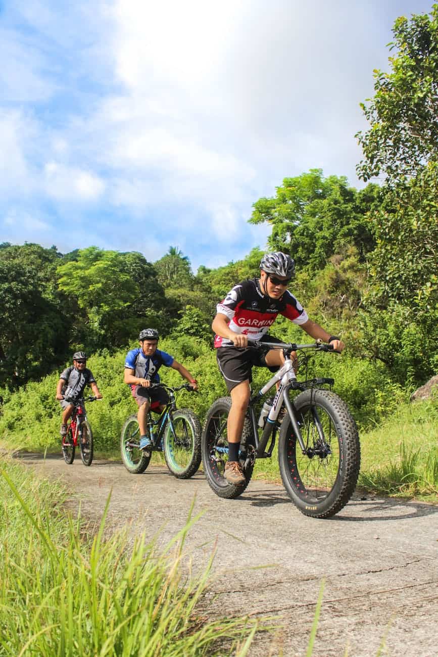 three men riding on bicycles