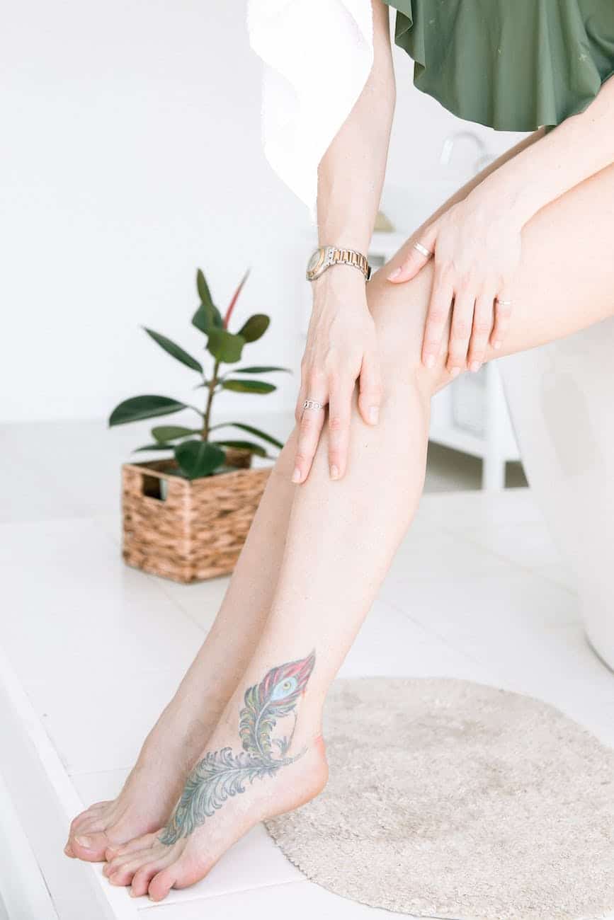 photo of person holding her shin leg