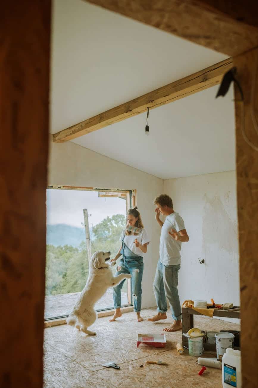 a happy couple dancing with their dog