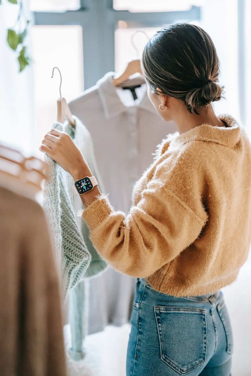 anonymous woman choosing outfit in store