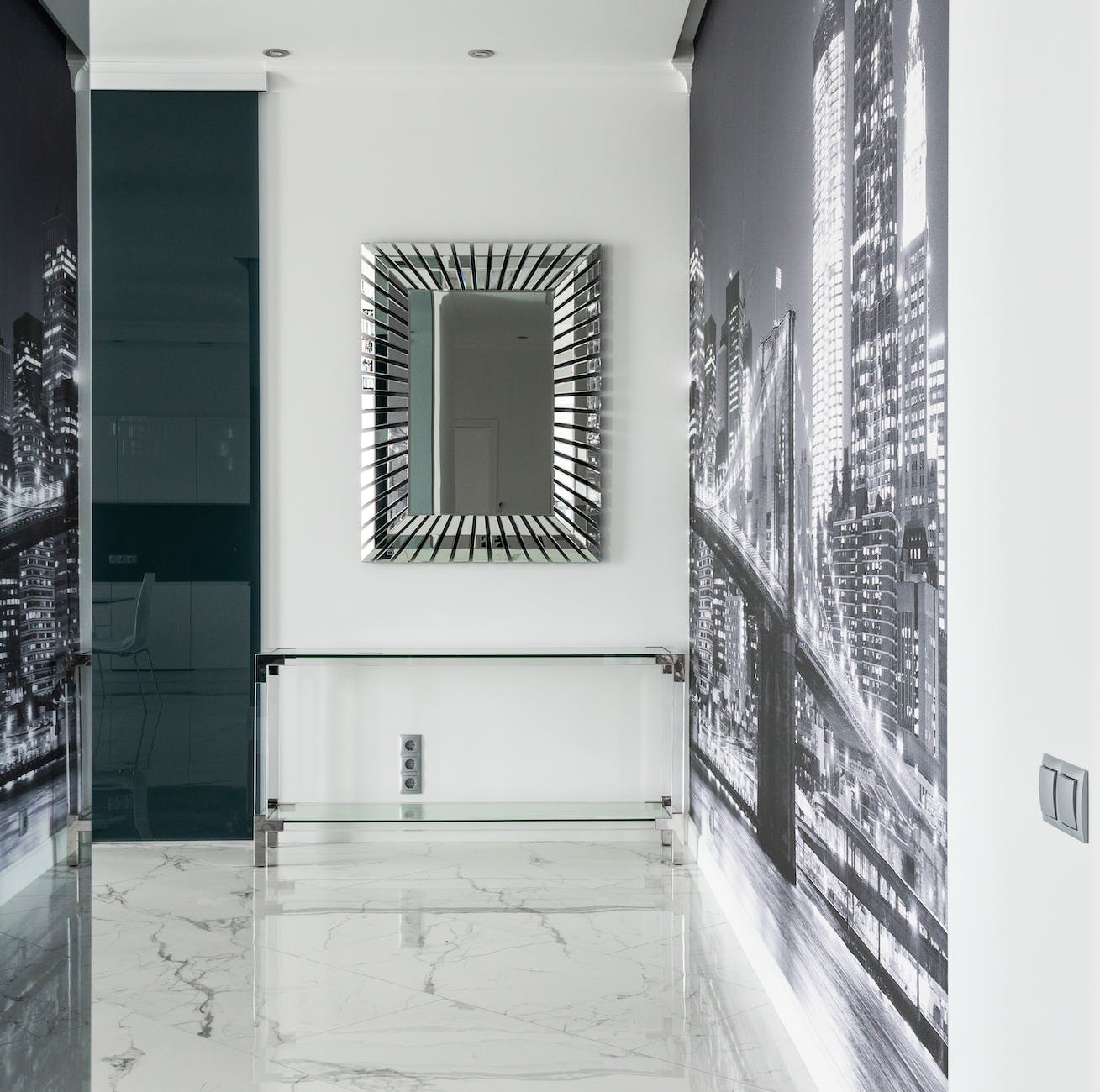 apartment interior with mirror and table near city wall mural