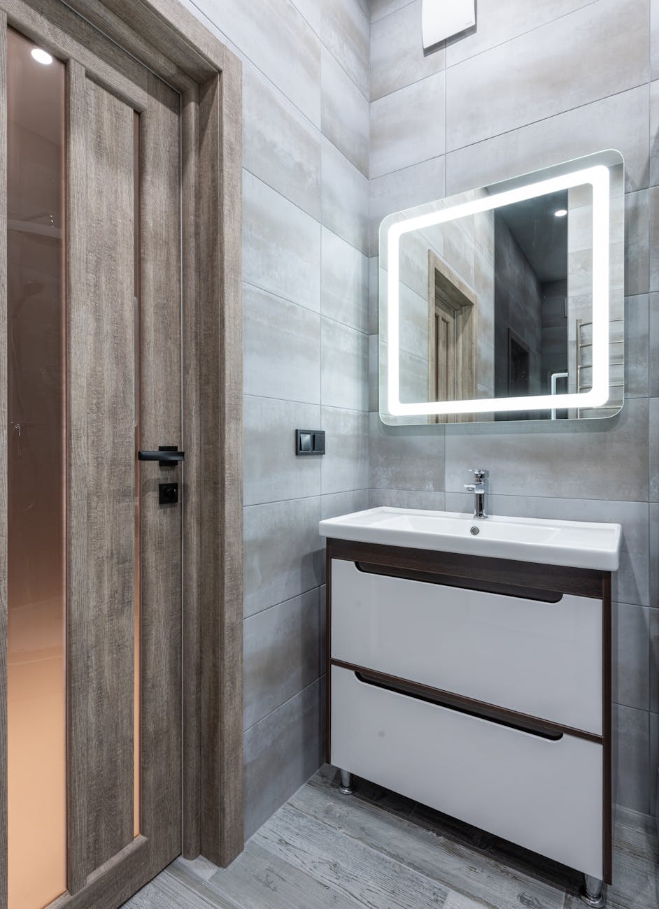 contemporary bathroom interior with washbasin under mirror in house