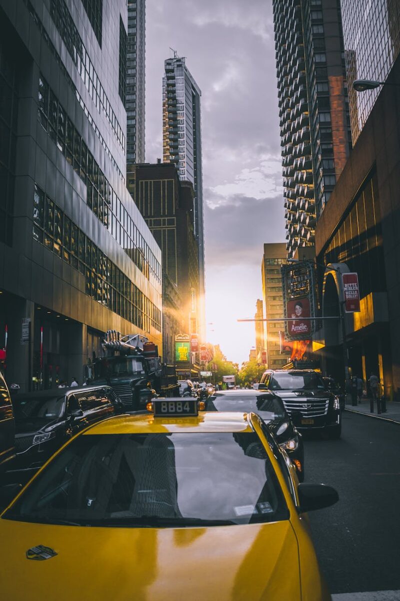 photo of cars on asphalt road near buildings