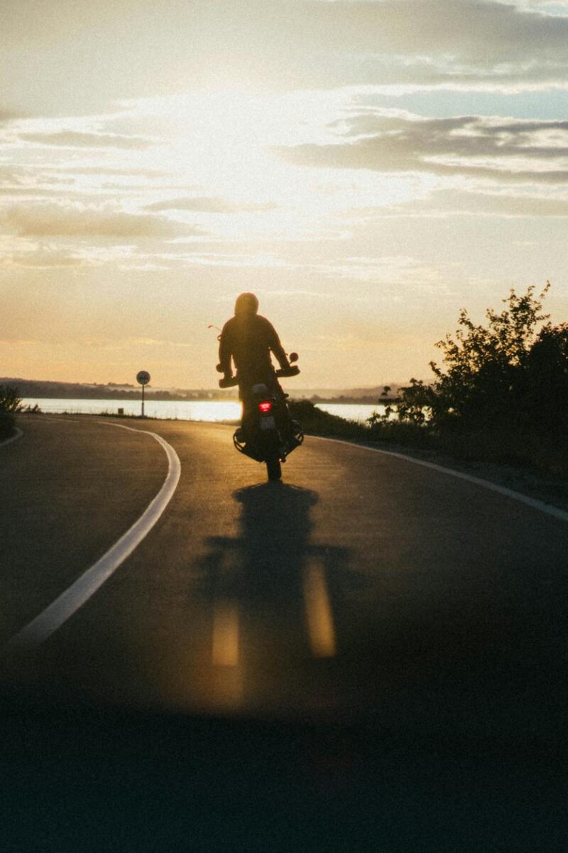 person riding motorcycle during golden hour