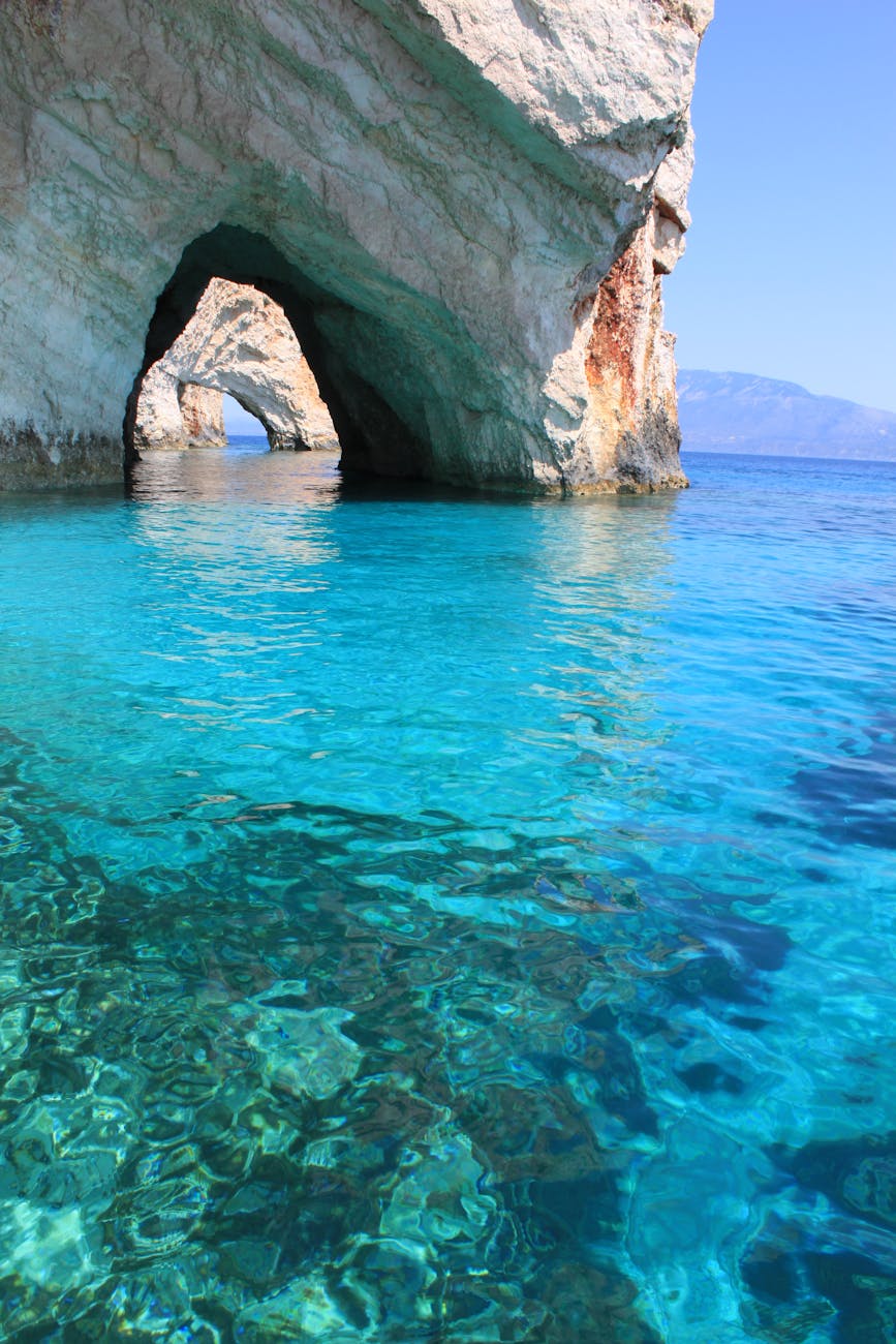 brown rock formation on blue water