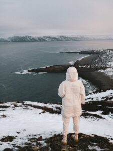 woman standing on a seashore on north pole