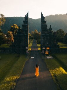 back view of a woman walking towards the famous bali handara gate