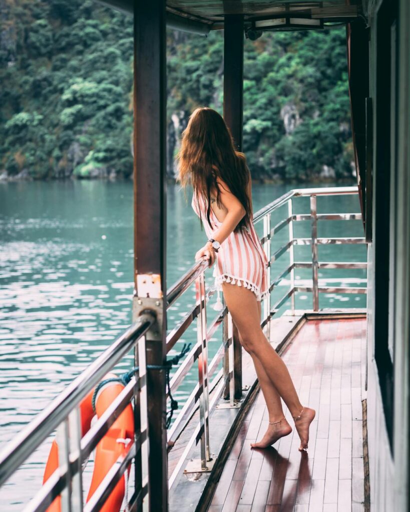 woman in black and white stripe bikini standing on the balcony