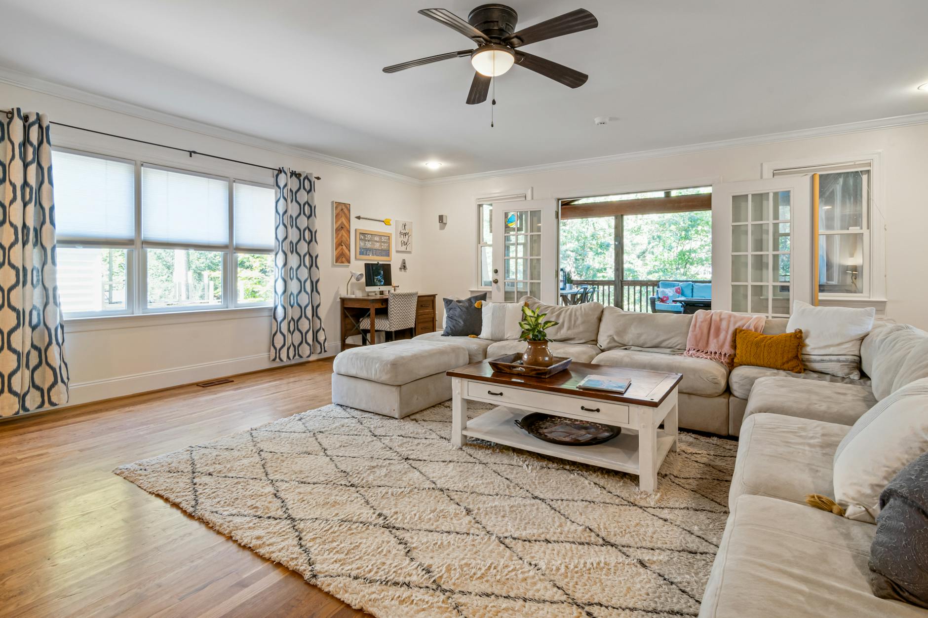 wide angle view of a bright spacious living room with carpet
