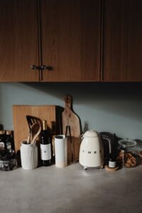 countertop with utensil and cabinets in cozy kitchen
