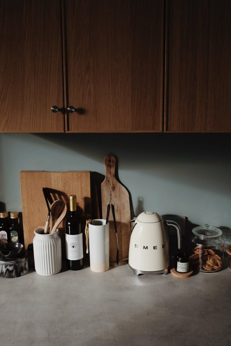 countertop with utensil and cabinets in cozy kitchen