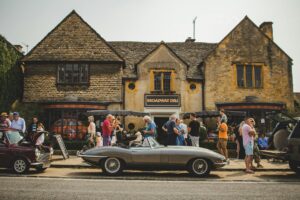a group of people standing outside of a pub